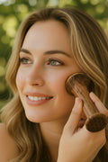 woman using a kansa facial massager outside, enjoying the sunlight and the de-inflammatory properties of the kansa wand